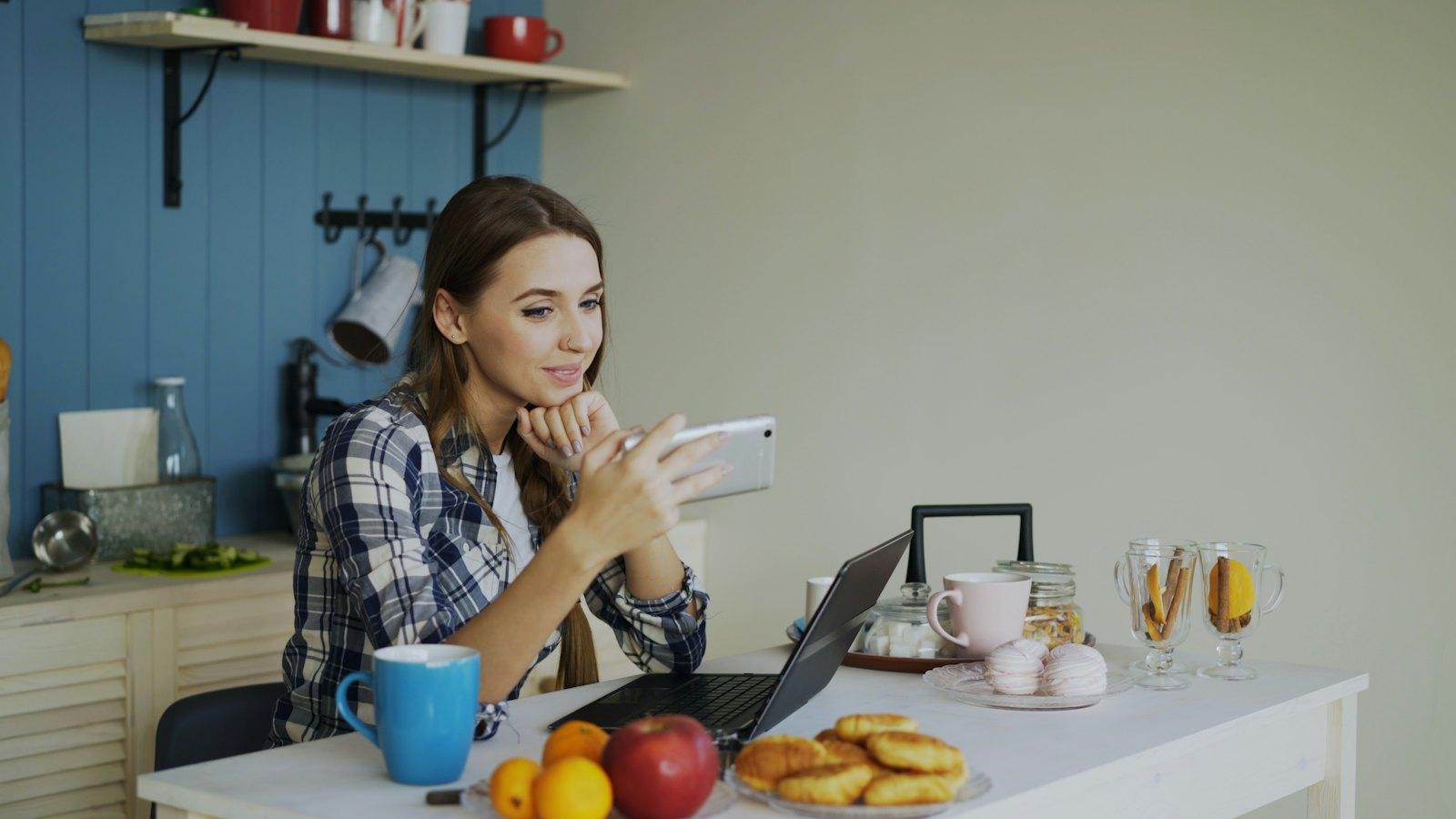 Woman smiling at a text at home