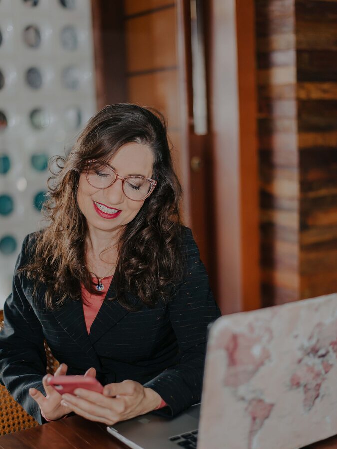 Businesswoman smiling as she replies to a message