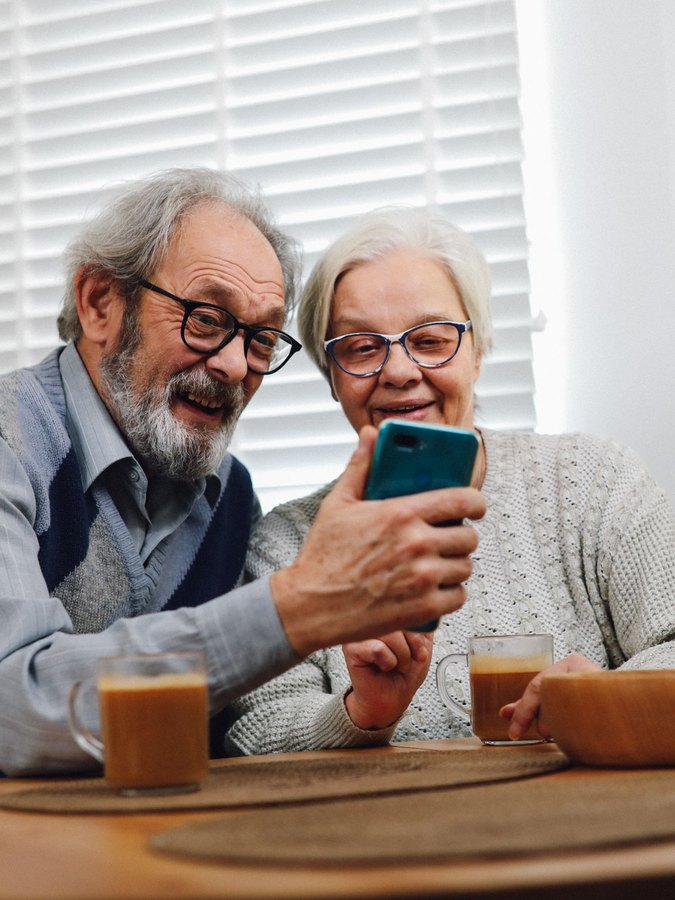 Grandparents waving on a video call
